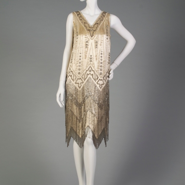 American, ca. 1920-1929. Dress decorated with beads and pearls with a zig-zag hem.
